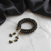 Black beaded bracelet with gold chain