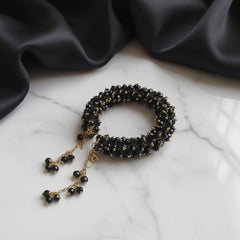 Black beaded bracelet with gold chain