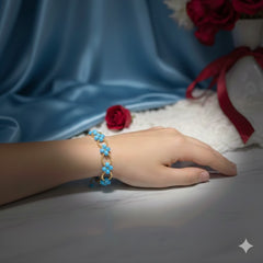 Hand wearing a blue beaded bracelet