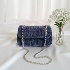 Blue velvet handbag with a chain strap