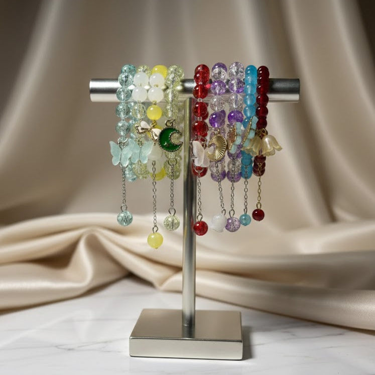 Colorful glass pearl charm bracelets on a metal stand