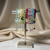 Colorful glass pearl charm bracelets on a metal stand
