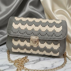 Gray and white patterned handbag with gold chain