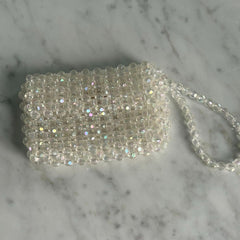 Silver beaded clutch bag on a marble surface