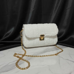 White textured handbag with gold chain strap