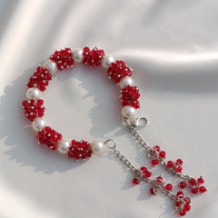 Bracelet with red floral beads and a silver chain