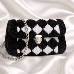 Black and white checkered handbag with chain