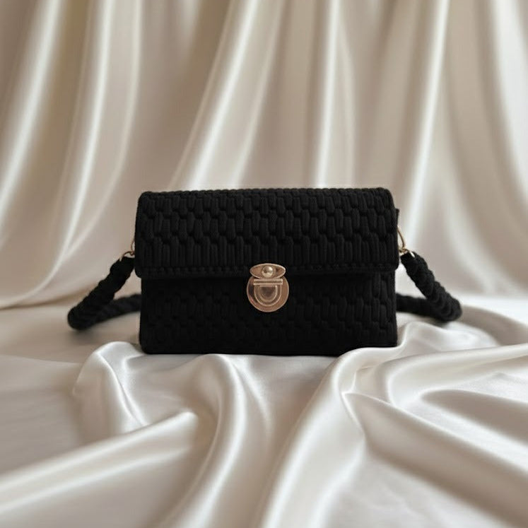 Black t shirt yarn handbag with a gold clasp 