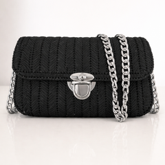 Black knitted handbag with a silver chain on a white background