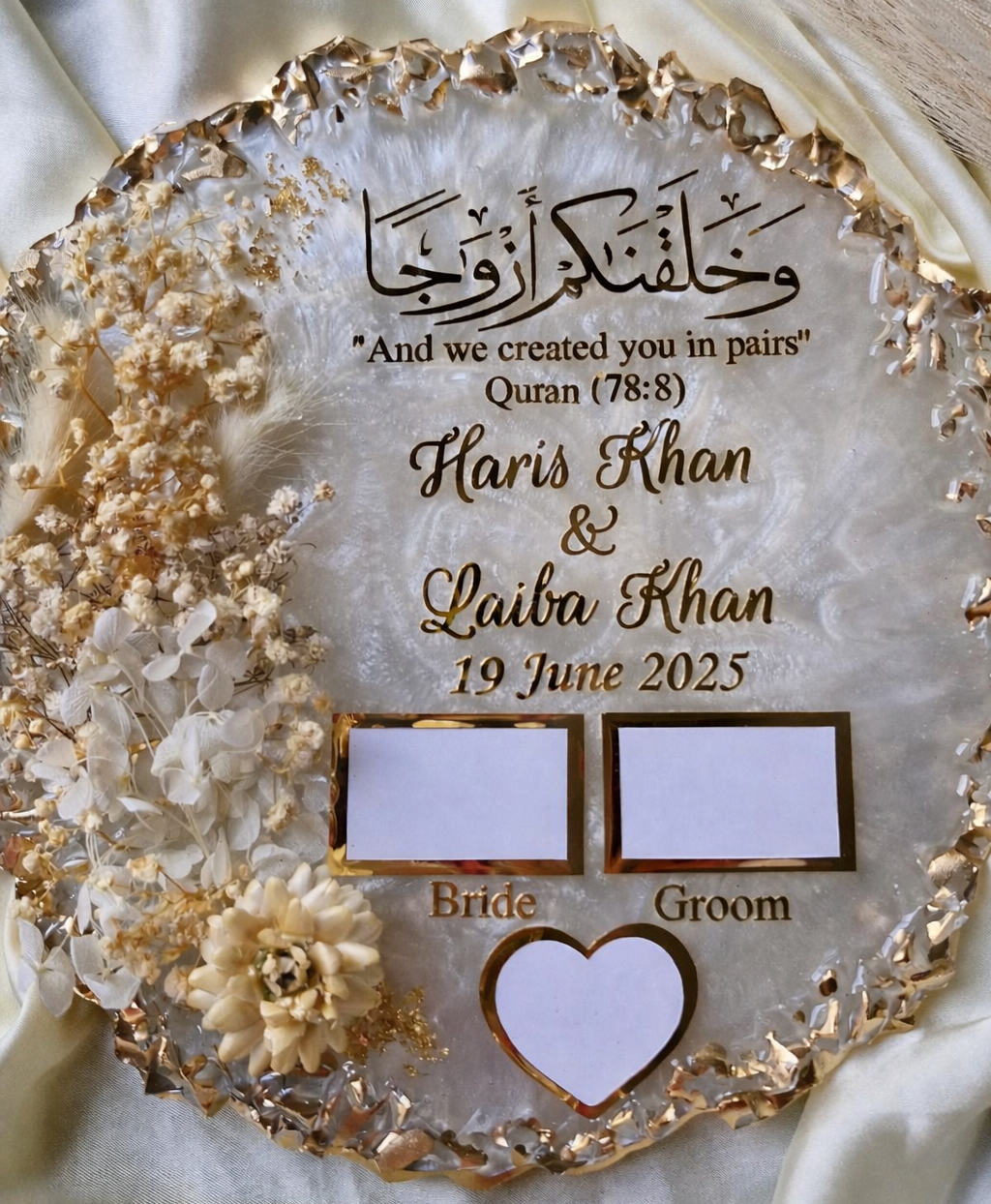 Decorative plaque with engraved names and date on a textured surface