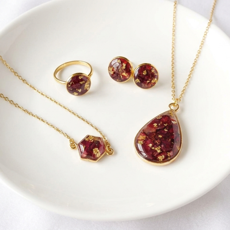 Jewelry set with red teardrop-shaped stones on a white plate