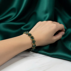 Hand wearing a green beaded bracelet 