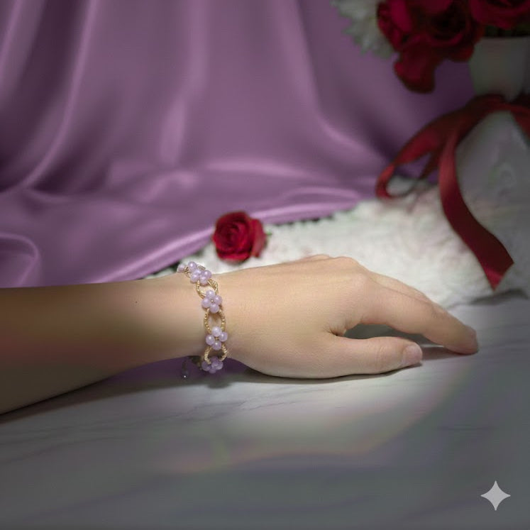 Hand wearing a purple bracelet 