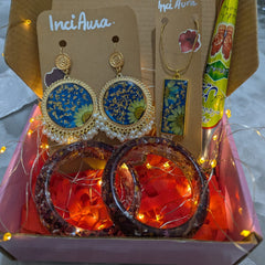 Jewelry set with earrings and bangles in a box, featuring 'Inci Aura' brand.