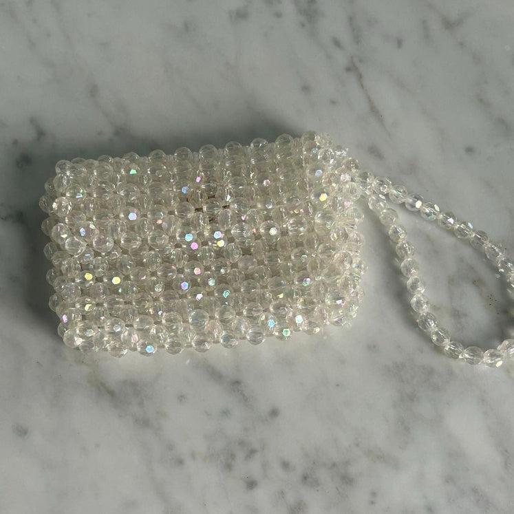Silver beaded clutch bag on a marble surface