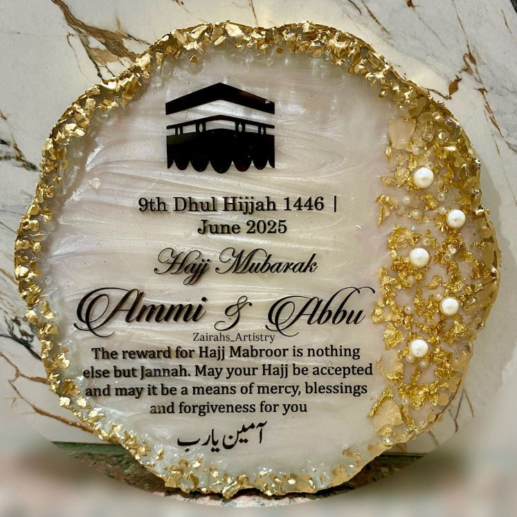 Decorative plaque with gold rim and text on a marble surface