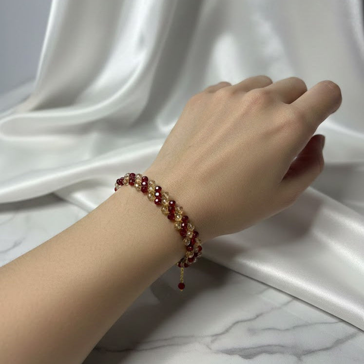 Hand wearing a beaded bracelet 