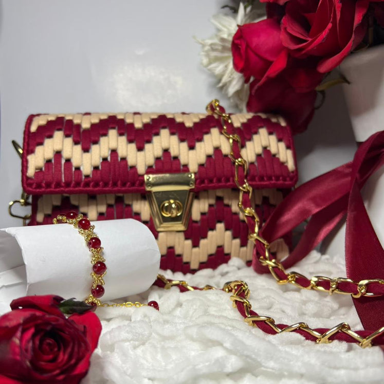 Red and gold handbag with floral decorations on a white background