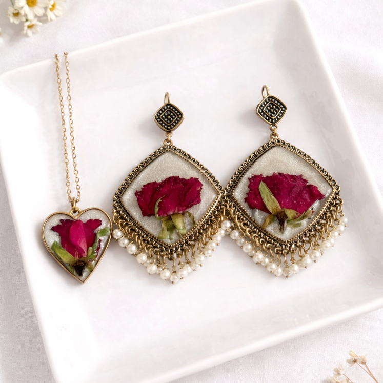 Jewelry set with red rose embedded stones on a white plate
